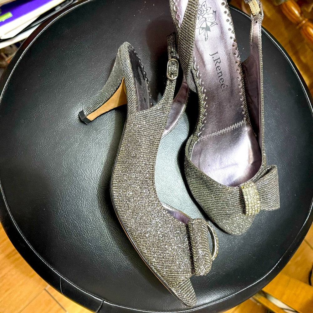 Pair of sandals, silver color, with metal decoration and crystals on the front.